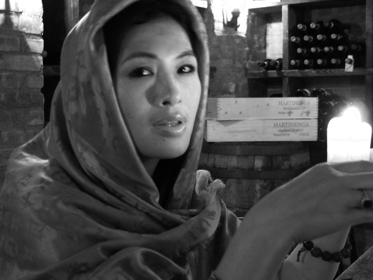 Black and white portrait of Grace Chang in a silk scarf by candlelight